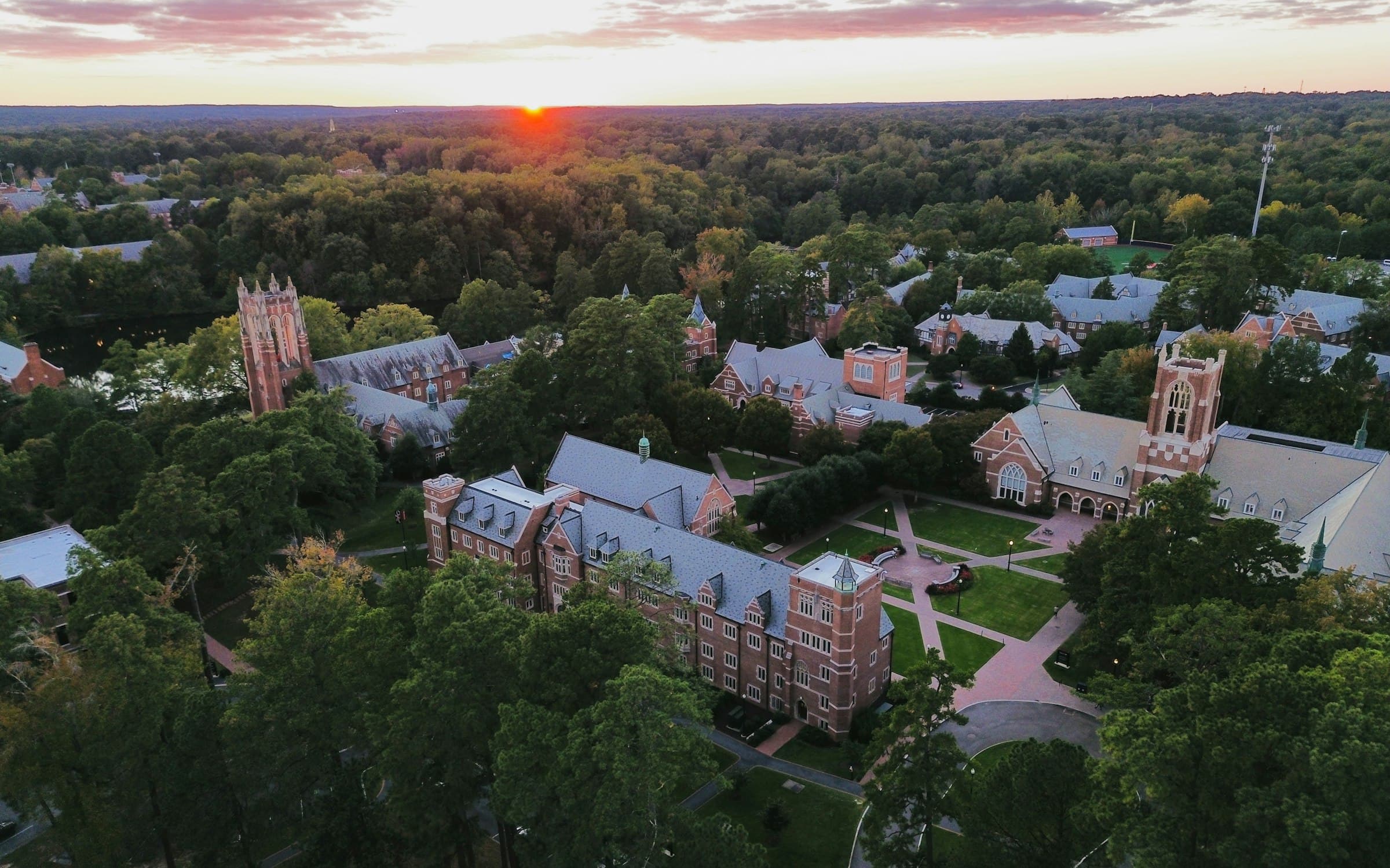 A student walking through a bright university campus